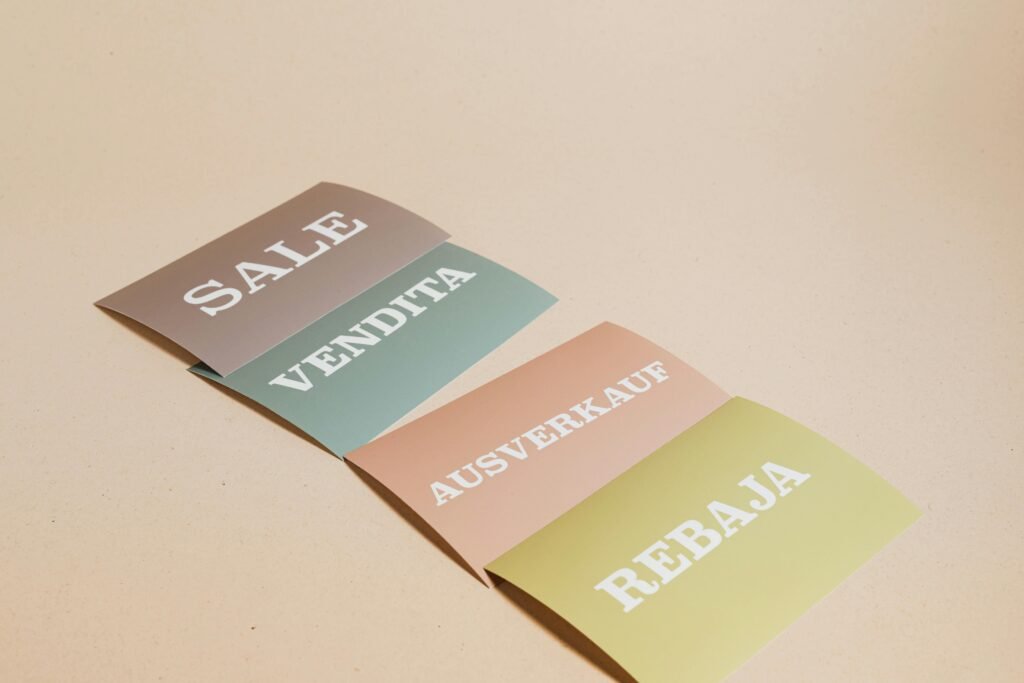 "Sale" on pastel cards in 4 languages
